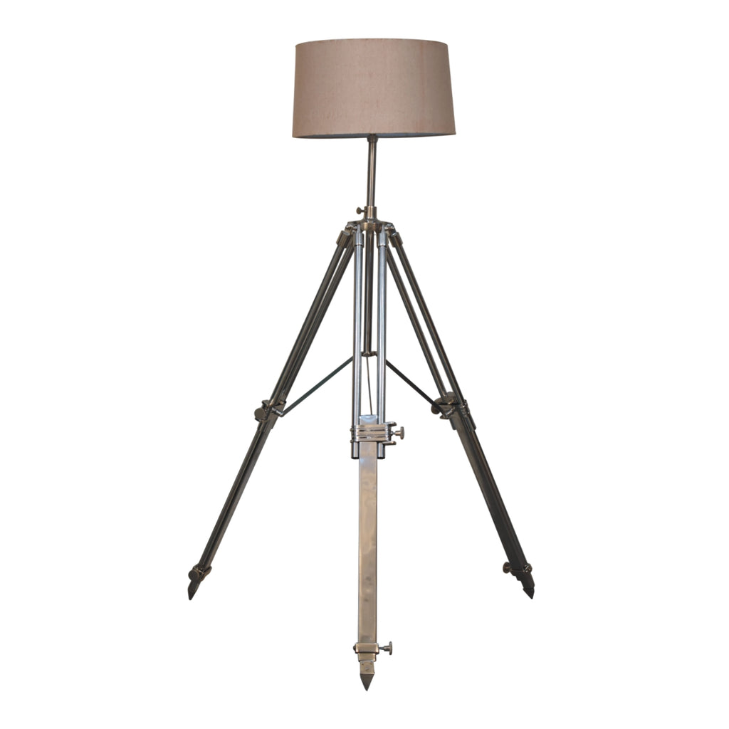 Chrome tripod lamp in living room setting