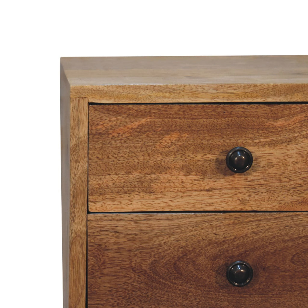 Mini oak bedside table in compact bedroom interior